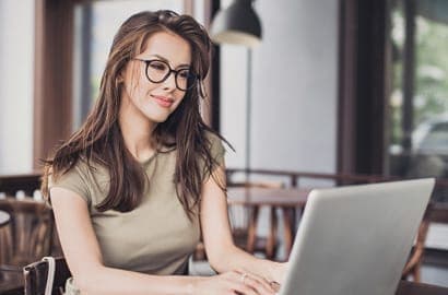 Admissions lady smiling at computer