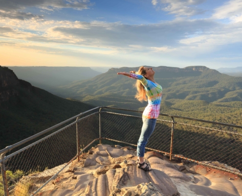 confident happy woman on top of a mountain