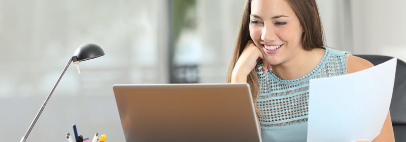 Woman Smiling at Computer