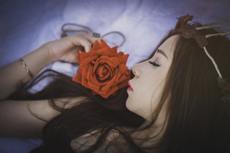 Long-Haired Woman Lying With Rose