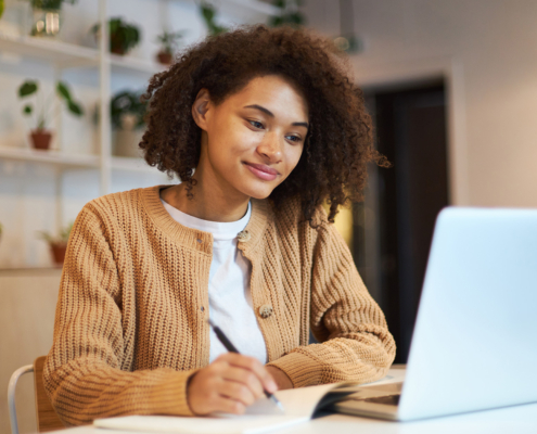 Front view of young woman looking at laptop screen