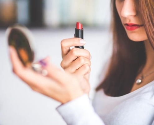 Woman Holding Lipstick and Compact