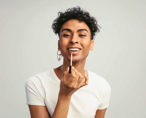 Image of a person applying lip gloss.