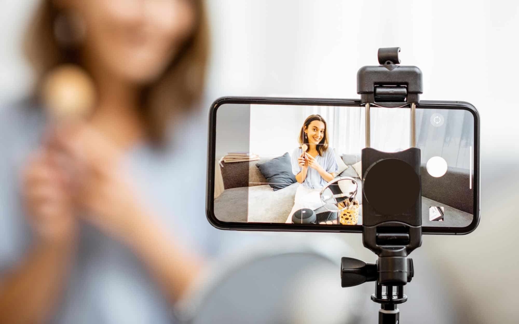 Image of a person filming themselves putting on makeup.