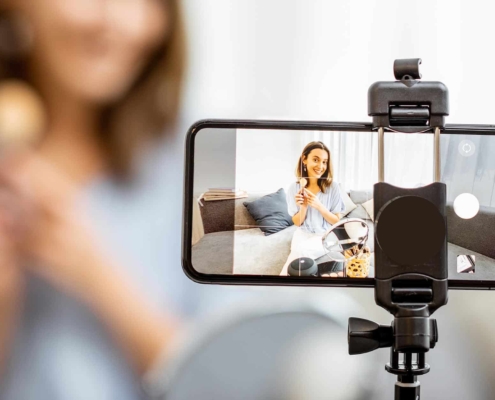 Image of a person filming themselves putting on makeup.