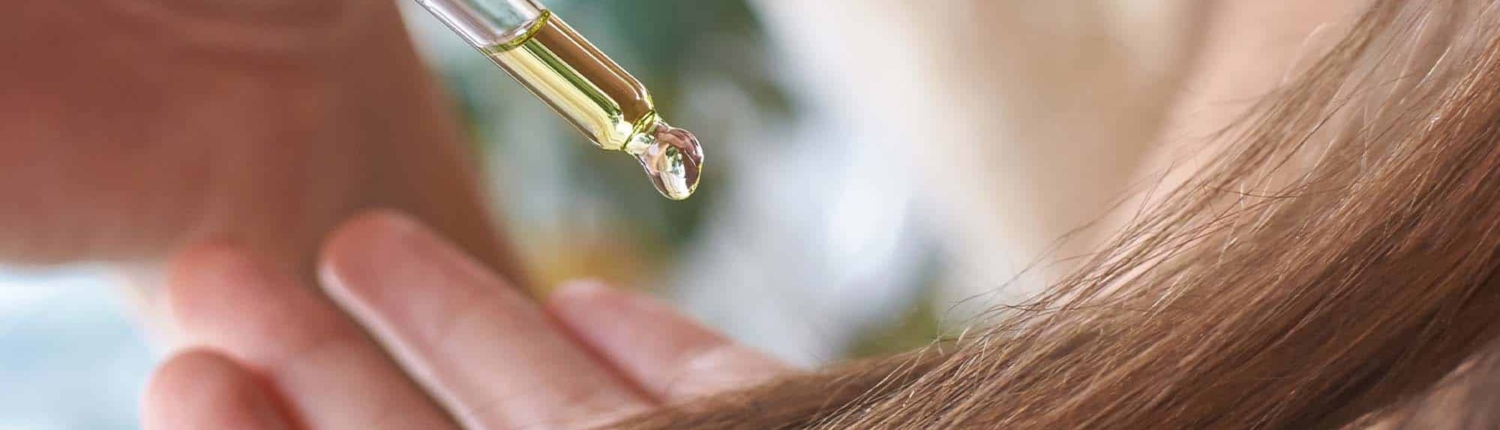 Long hair care routine. Oil for head. Girl holding dropper with castor mask near hair