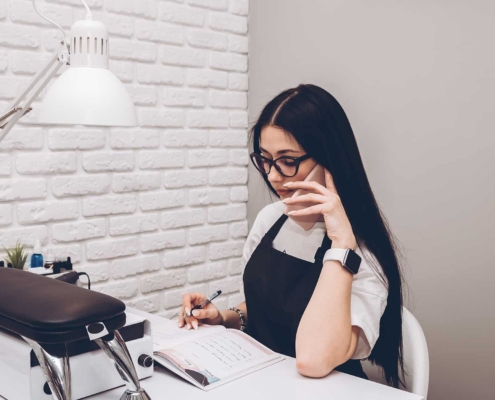 Woman On the Phone Managing Her Salon