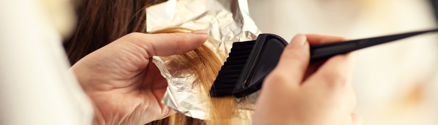 Side View Of A Cosmetology Student Applying Color To A Clients Hair Using Foils 1500x430.jpg.jpg