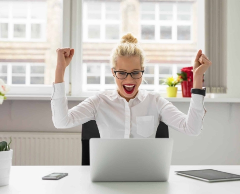 woman happy in front of computer