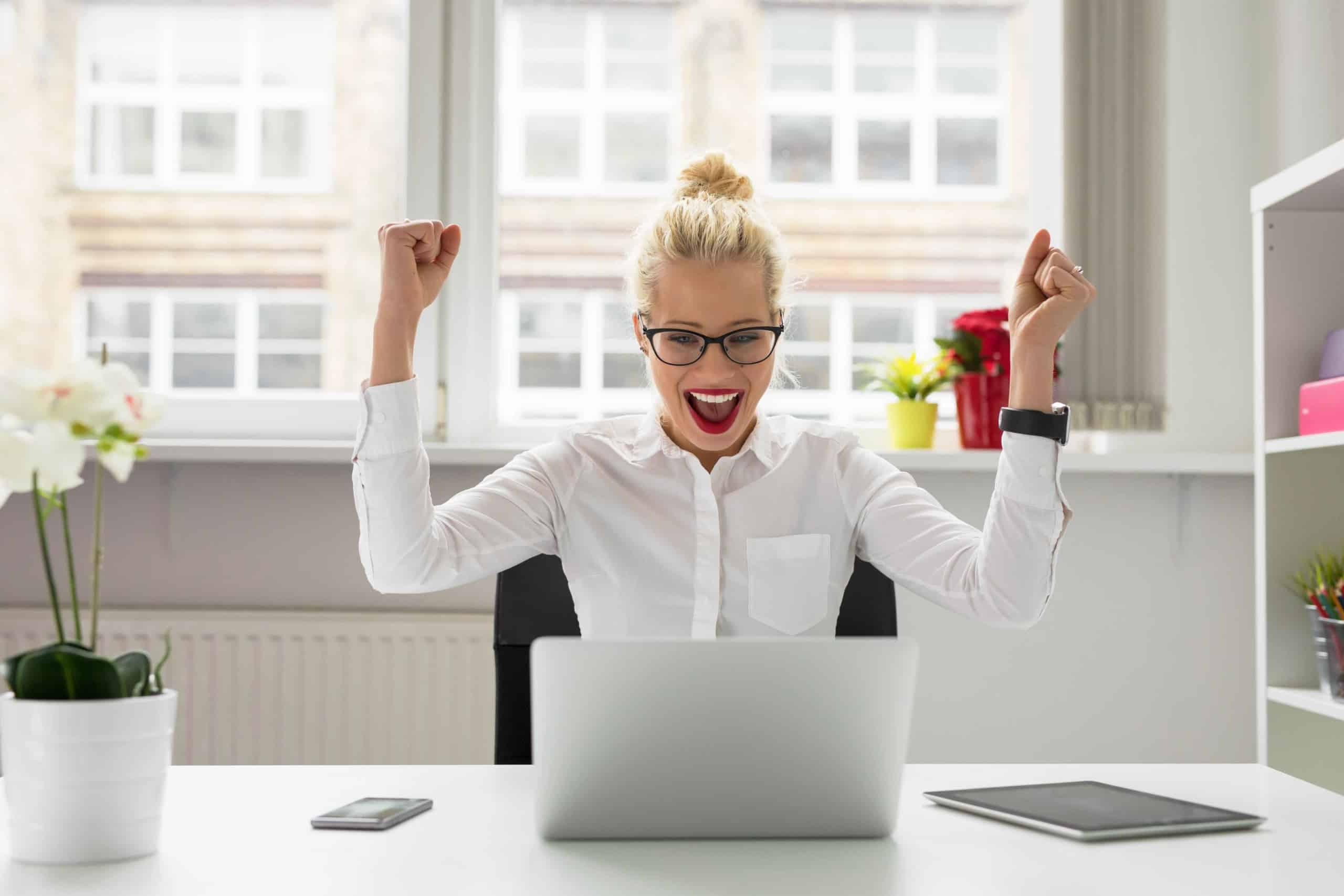 woman happy in front of computer