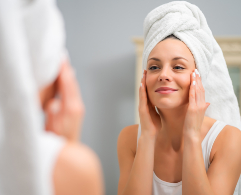 Portrait Of Young Happy Woman Who Is Satisfied With Her Skin