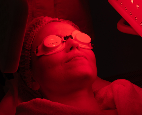 Woman Receiving Red Light Therapy Treatment For Skin Rejuvenation